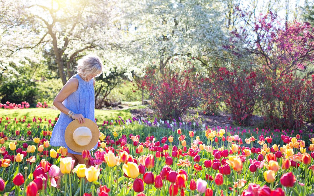 Woman walking through flowers in spring - The Peres Team at Nationwide Mortgage Bankers