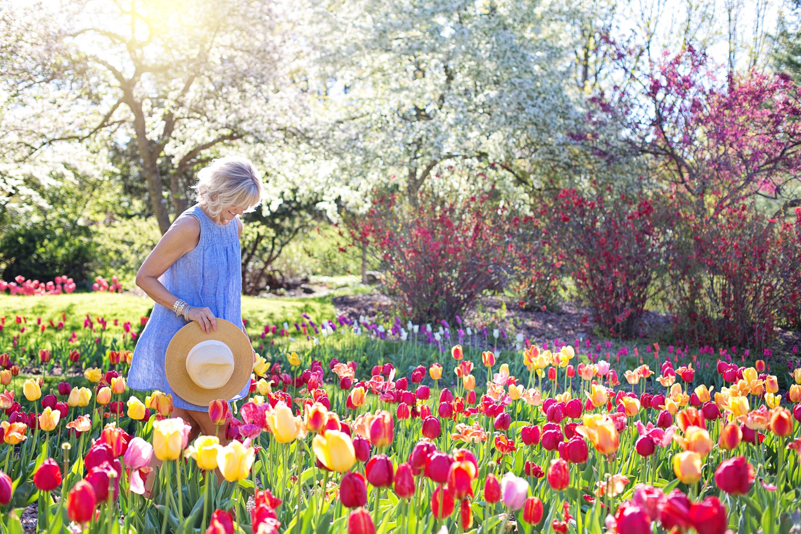 Woman walking through flowers in spring - The Peres Team at Nationwide Mortgage Bankers